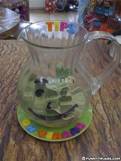 a glass pitcher sitting on top of a table with the word happy written in it