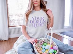 An easter themed spring mockup of the Bella and Canvas 3001 tshirt in the color silver. Modeled by a woman holding an easter basket.