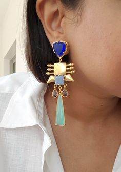 Introducing our Long Boho Style Unique Blue Statement Dangle Earrings, a stunning fusion of elegance and creativity that will elevate your style to new heights. Crafted with care and attention to detail, these earrings feature natural blue chalcedony stones that exude a serene beauty. The multiple elements of gold brass add a touch of luxury and sophistication, while the mix of colors creates a harmonious flow that captures the eye. Each earring boasts different shapes and layers of design, givi Nice White Dresses, Chalcedony Earrings, Earrings Indian, Chalcedony Stone, Indian Earrings, Blue Chalcedony, Gold Polish, Boho Stil, Boho Style