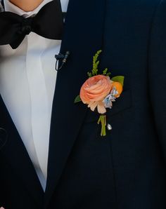 a man in a tuxedo with a boutonniere on his lapel