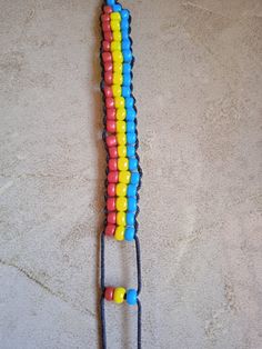 a pair of headphones that are made out of legos and plastic beads, sitting on the floor