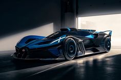 a blue and black sports car parked in a garage with light coming through the window