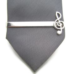 "- Silver Clef tie Clip This listing is for one silver-tone tie clip, featuring a clef design. This is a lovely gift for anyone who anyone who loves music. - Dimensions The tie clip is approx 2\" inches (approx 5cm)  in length. Available with an expertly presented gift box. Please select gift wrapping at check for this to be applied to your order. Thank you." Adjustable Silver Ties For Black Tie Events, Silver Ties For Black Tie Occasions, Silver Ties For Father's Day Gift, Silver Adjustable Accessories For Black Tie Suit, Adjustable Silver Suit And Tie Accessories For Black Tie, Classic Silver Tie, Classic Silver Adjustable Suit And Tie Accessories, Classic Adjustable Silver Suit And Tie Accessories, Clip Music