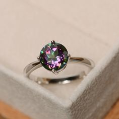 This ring features a 8mm round cut mystic topaz and sterling silver finished with rhodium. Customization is available. It is made by hand, and it will take about 7 days to finish the ring after your payment is completed. Any question, just let me know. :) My shop homepage: https://www.etsy.com/shop/LuoJewelry?ref=l2-shopheader-name Vintage Blue Sapphire Ring, Rainbow Topaz Ring, Rings Birthstone, Topas Ring, Handmade Wedding Gifts, Rainbow Topaz, Green Sapphire Ring, Friend Rings, Mystic Topaz Ring