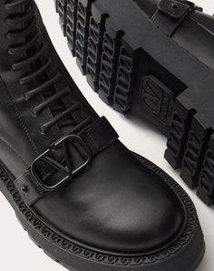 Valentino Garavani combat boot in calfskin with VLogo Signature decoration - Strap with custom VLogo Signature buckle in tone-on-tone finish - Inner side zip - Custom welt with embossed VLogo Signature motif - Rubber lug sole - Heel height: 45 mm / 1.8 in. with 25 mm / 1 in. platform - Shaft height: 15 cm / 6 in. in an Italian size 37 - Made in Italy Luxury Platform Boots With Lug Sole, Luxury Calf Leather Lace-up Boots With Lug Sole, Luxury Lace-up Boots With Lug Sole In Calf Leather, Luxury Ankle Lace-up Boots With Lug Sole, Luxury Lace-up Ankle Boots With Lug Sole, Luxury Ankle Combat Boots With Lug Sole, Luxury Ankle Moto Boots With Lug Sole, Luxury Calf Leather Platform Boots With Leather Sole, Luxury Moto Boots With Lug Sole