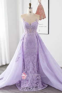 a purple dress on display in front of a mannequin headdress with an open back