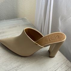 It Is Beige With Gold Logo Square Heel And Fine Point Good Material Elegant Beige Pointed Toe Mules, Elegant High Heel Beige Mules, Elegant Beige High Heel Mules, Beige Designer Mules For Formal Occasions, Designer Beige Mules For Formal Occasions, Elegant Beige Mules For Office, Classic Cream Mules For Formal Occasions, Elegant Beige Almond Toe Mules, Chic Cream Pointed Toe Mules