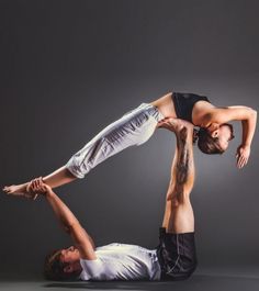 a man and woman doing yoga poses on their back with one leg in the air