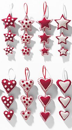 red and white ornaments hanging from strings on a wall in the shape of hearts, stars and flowers