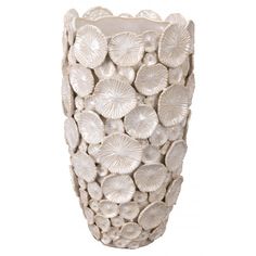 a white vase with shells on it