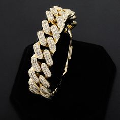 Is it hot in here, or is it just this bracelet? The 18m Miami Big Box Clasp Cuban Bracelet is the perfect accessory for a steamy summer night. This beautiful bracelet is crafted with high quality 14k gold plating and features a dazzling Cuban design. Whether you're hitting the town or the beach, this bracelet will add a touch of sophistication to your look. And at such an affordable price, it's a must-have for any fashionista on a budget. So don't wait any longer, grab the 18m Miami Big Box Clas Iced Out Cuban Link Bracelets For Party, Iced Out Cuban Link Bracelet For Party, Iced Out Cuban Link Party Bracelet, Rose Gold Cuban Link Bracelet As Gift, Rose Gold Cuban Link Bracelet, Adjustable Gold Iced Out Bracelets, Cuban Design, Is It Hot In Here, Cuban Bracelet