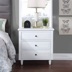 a bedroom scene with focus on the nightstand and bed