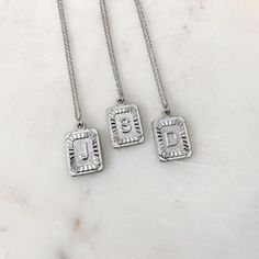 Silver Initial Letter Pendant Necklace Silver Rectangular Initial Necklace, Elegant Silver Rectangular Initial Necklace, Silver Engraved Initial Necklace With Square Pendant, Silver Engraved Square Pendant Initial Necklace, Silver Engraved Initial Rectangular Necklace, Personalized Silver Initial Necklace With Square Pendant, Trendy Silver Jewelry With Initials, Elegant Silver Rectangular Charm Necklace, Silver Initial Necklace With Rectangular Pendant