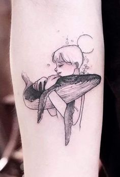 a woman with a whale tattoo on her arm