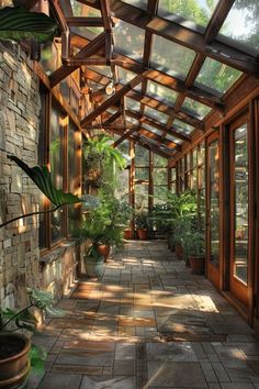 the inside of a building with lots of windows and plants