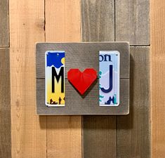 two magnets with the word i love you on them are mounted to a wooden wall