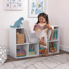 The KidKraft Bookcase with Reading Nook is popular with parents because of its clever design, sturdy construction and aesthetic appeal. Combining a cushioned seating area with bookshelves gives you two spaces in one furniture piece. Kids can store books, toys, blankets and more in the six shelves, then curl up on the three-sided angled middle section to read or rest. The two tall shelves on the sides are perfect for accommodating taller picture books. Place a lamp on the top sides for cozy light. Three gray cushions stay securely onto the base with self-adhesive strips. Available in trend-right colors to match your home's décor, the Bookcase with Reading Nook will help keep any kids room or playroom organized and neat. Crafted of premium, recyclable materials for long-lasting play Recommen Bookcase Aesthetic, Kids Storage Shelves, Toddler Storage, Childrens Shelves, Kids Clubhouse, Kids Cabinet, Tall Shelves, Storage Cabinet Shelves, Playroom Organization