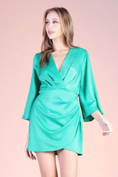 An absolute lux dress! Pair with gold jewelry, a pair of heels and you will be sure to stand out. This piece features mid length kimono - style sleeves and a mini overlay skirt. V neckline Elastic-lined waist Mini length Wrap skirt-area Pullover Semi-textured satin finish 100% Polyester Made in USA SKU #: D-8042 Chic Satin Mini Dress With Draped Sleeves, Long Sleeve Faux Wrap Party Dress, Spring Party Midi Dress With Faux Wrap, Party Midi Dress With Draped Sleeves And Surplice Neckline, Satin V-neck Mini Dress For Brunch, Elegant Spring Mini Dress With Faux Wrap, Spring Formal Faux Wrap Dress, Formal Faux Wrap Dress For Spring, Spring Satin Mini Dress For Formal Occasions