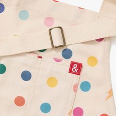 a polka dot bag with a belt on it