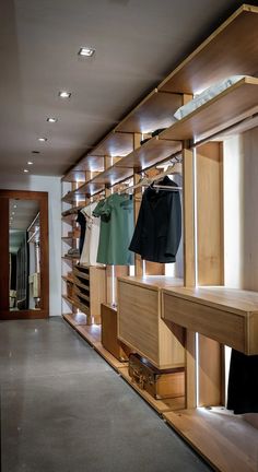 an empty store with wooden shelves and clothes on hangers