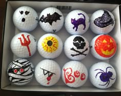 a box filled with lots of golf balls covered in different designs and colors on them