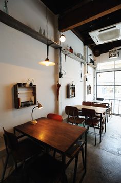 an empty room with tables and chairs in it