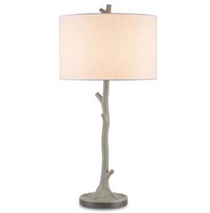 a table lamp with a white shade on it's base and a bird perched on the branch