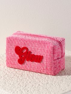 a small pink bag with the word love on it