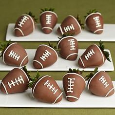 chocolate covered strawberries are arranged in the shape of footballs