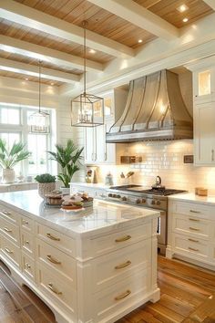 a large kitchen with white cabinets and wood flooring on the walls, along with an island in the middle