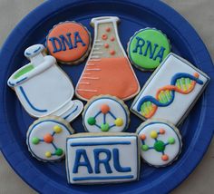 some cookies are on a blue plate with the word arl written in white letters