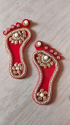 two pairs of red and gold beaded shoes