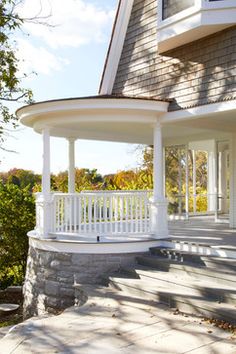 a white porch with steps leading up to it