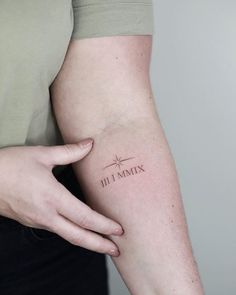 a woman's arm with a tattoo that says dj mix on it and a cross in the middle