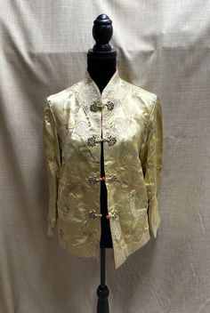 "Stunning reversible bright gold Chinese style jacket with floral print on one both sides.  Quilted cuffs, front, and pockets. Toggle closures on both sides. Mandarin collar. No tags or markings. In excellent condition. Unknown material but feels like silk or satin. Measurements (laid flat): Waist - 20\" Hips - 20\" Pit to pit - 19\" Collar opening - 5\" Shoulder to shoulder - 16\" Pit to sleeve hem - 16\" Shoulder to sleeve hem - 21.5\" Center of collar to bottom hem - 27\" Shoulder to bottom h Gold Long Sleeve Outerwear For Spring, Gold Blazer With Gold Buttons For Spring, Gold Long Sleeve Outerwear With Button Closure, Spring Outerwear With Gold Buttons And Long Sleeves, Fitted Gold Embroidered Outerwear, Gold Embroidered Long Sleeve Outerwear, Traditional Gold Long Sleeve Outerwear, Gold Outerwear With Long Sleeves And Gold Embroidery, Vintage Gold Long Sleeve Outerwear