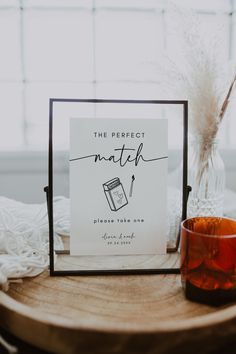 the perfect match sign is next to a glass with some sort of candle on it