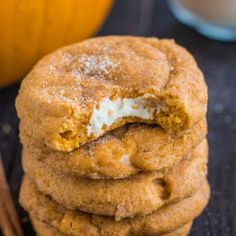 a stack of cookies sitting on top of a table next to an orange and cinnamon stick