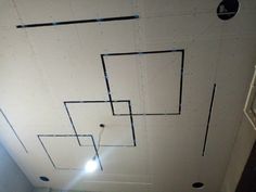 the ceiling is painted white and has blue tape on it, as well as black dots