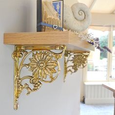 a shelf with decorative items on it in a room next to a door and window