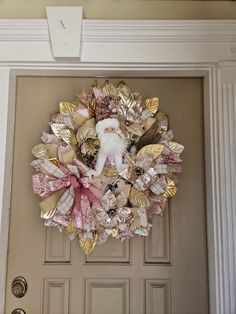 a wreath with a santa clause on it is hanging on the front door to welcome guests