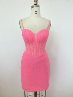 a pink dress on a mannequin stand