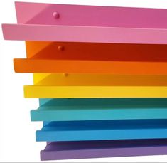 a stack of multicolored wooden shelves against a white background