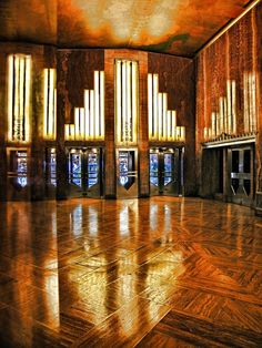 the inside of an old building with wooden floors and large windows that are lit up