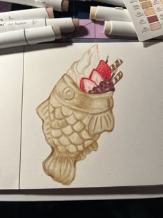 some watercolors are laying on top of each other and there is a drawing of a fish with strawberries in it