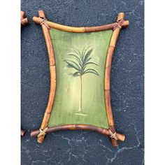 a bamboo frame with a palm tree painted on it