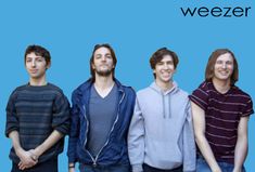 three men standing next to each other in front of a blue background with the words weezer on it