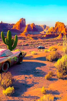 a car is parked in the desert with a cactus