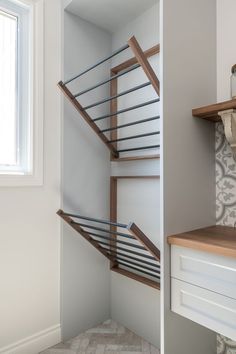 the stairs in this bathroom are made of wood and metal, with tile on the floor