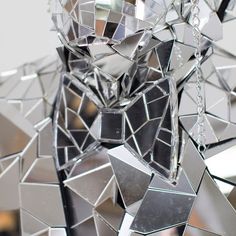 an animal made out of mirrors and chains