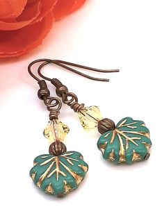 Premium czech glass maple leaf dangle earrings have a gold wash finish.  They are cute and have a 1" drop from bottom of ear wires.  Each maple leaf is topped with a brass bead followed by a Swarovski crystal bead.  They are also hypoallergenic which is a plus if you are sensitive.   Comfortable and easy to wear everyday.  BoHo Hippie but they combine simplicity and charm. Their beauty will surely pop up any outfit. The item pictured is the item you will receive and is ready to ship.  It arrives on an earring card in an organza pouch ready for gift giving or for your own personal pleasure. You can visit my shop at: https://www.etsy.com/shop/RMBJewelryDesigns Boho Tassel Keychain, Boho Yellow, Wire Wrap Jewelry Designs, Earrings Ideas, Organza Pouch, Earring Card, Earring Ideas, Tassel Keychain, Swarovski Crystal Beads